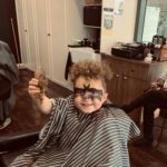 A Kid Smiling And Haircut — Hair And Beard Styles in Hope island, QLD